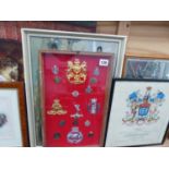 A FRAME OF MILITARY EMBLEMS AND PRINTS AND PICTURES.