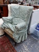 AN EDWARDIAN WING BACK CHAIR.