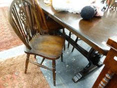 A SET OF FOUR WHEELBACK CHAIRS AND A REFECTORY STYE DINING TABLE.