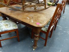 A VICTORIAN MAHOGANY EXTENDING DINING TABLE.