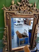 A LARGE GILT FRAMED MIRROR.