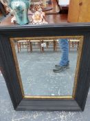 A LARGE WALL MIRROR AND A NURSING CHAIR.