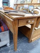 A DROP LEAF PINE KITCHEN TABLE.