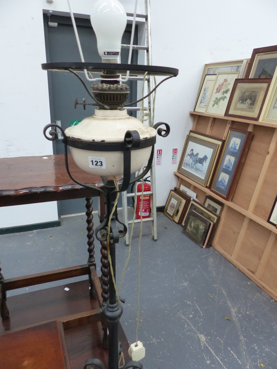 A WROUGHT IRON STANDARD LAMP.