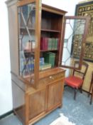 AN EDWARDIAN MAHOGANY BOOKCASE CABINET.