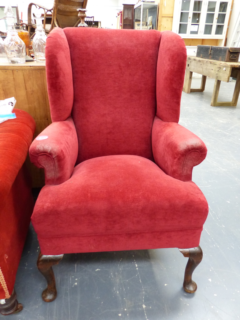 A WING BACK ARMCHAIR.