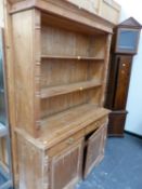 AN ANTIQUE PINE DRESSER.