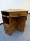 A ROWLEY LIMED OAK CORNER DESK FITTED WITH SHELVES AND CUPBOARDS. W.84 x H.77cms.