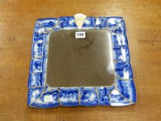 A SQUARE MIRROR IN A MOSAIC CERAMIC FRAME OF BLUE AND WHITE PRINTED PLATE RIM BANDS. 31 x 31cms.