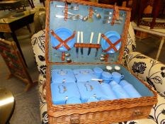 A VINTAGE CORACLE WICKER PICNIC HAMPER WITH FITTINGS.