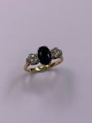 AN 18ct GOLD OVAL SAPPHIRE AND BRILLIANT CUT DIAMOND THREE STONE CLAW SET RING, FINGER SIZE P 1/2,