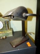 AN ART DECO DESK LAMP WITH ANODISED FINISH AND BAKELITE SHADE.