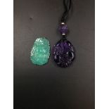 A CHINESE AMETHYST GLASS OVAL PENDANT WORKED WITH FRUIT AND FLOWERS. H 4.5cms A BEAD ABOVE ON THE