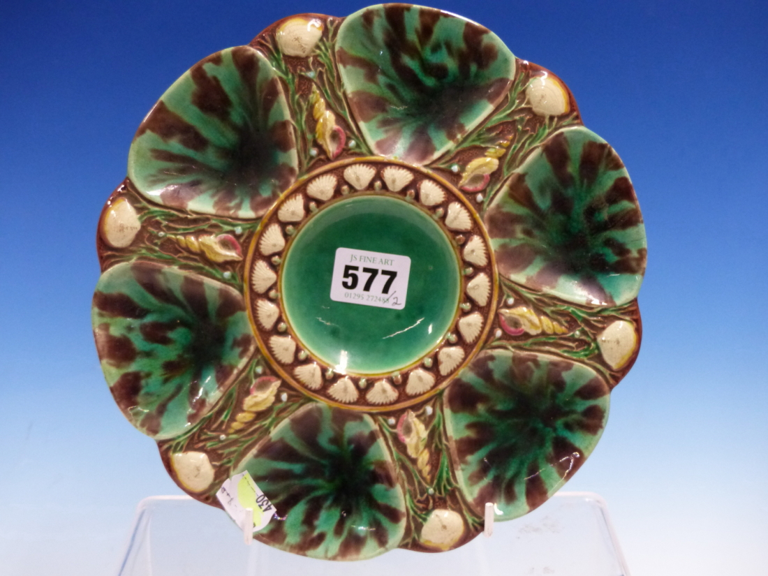 A MINTON MAJOLICA OYSTER PLATE, DATECODE FOR 1872, THE SIX AUBERGINED FLECKED GREEN COMPARTMENTS