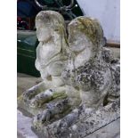 A PAIR OF ANTIQUE WEATHERED STONE FIGURES OF RECUMBENT SPHINX. L.77cms