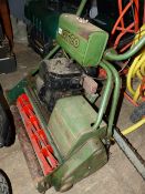 AN ATCO CYLINDER MOWER WITH RIDE-ON ROLLER SEAT.