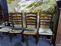 A HARLEQUIN SET OF 22 SIMILAR RUSH SEAT LADDER BACK CHAIRS