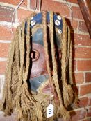 A DAN MASK THE WOOD PAINTED RED AND BLACK, THE PLAITED HAIR AND BEARD OF ROPE, THE HEAD BAND MOUNTED