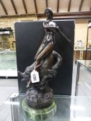 A BRONZE NUDE LADY RIDING A DOLPHIN THROUGH WAVES, BEARS SIGNATURE F PREISS, GREEN MARBLE PLINTH.