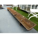 A GROUP OF FIVE ANTIQUE CAST IRON FEED TROUGHS.