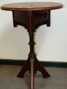 A NEOGOTHIC OAK TABLE, THE ROUND TOP CENTRED BY A TRIANGLE OF THREE PIECES OF WOOD ABOVE AN APRON