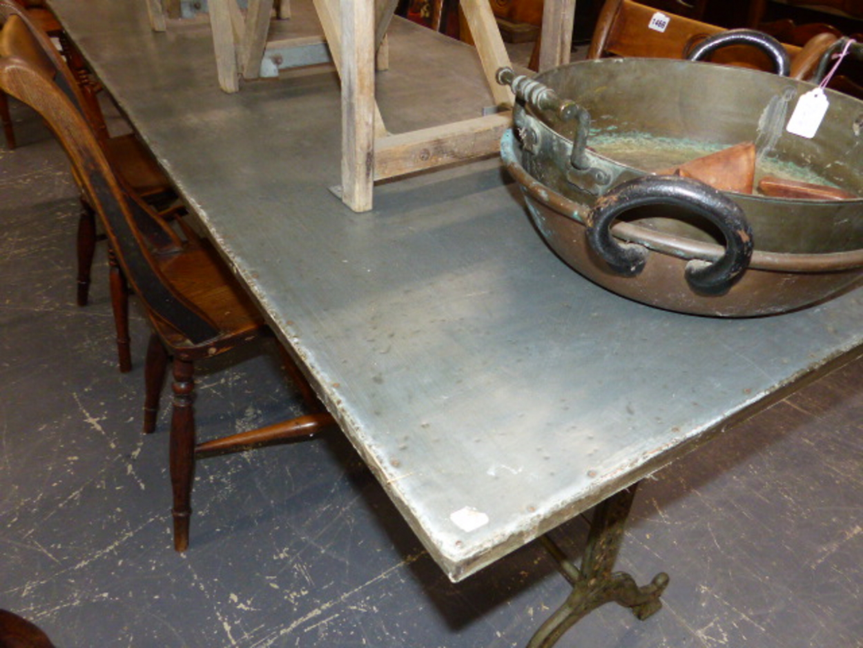 A SET OF THREE CAST IRON BASED TABLES WITH CAST IRON TRESTLE BASES AND ZINC WRAPPED TOPS. 69 x 210 x - Image 2 of 11