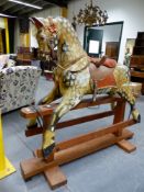 AN IMPRESSIVE EARLY 20th.C.ROCKING HORSE, THE DAPPLE GREY HORSE WITH LEATHER HARNESS AND VELVET