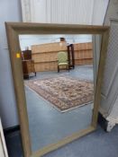 A MODERN PINE FRAMED WALL MIRROR. 89 x 120cms.