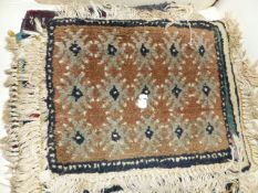 A BELUCHI SADDLE BAG TOGETHER WITH FIVE SMALL RUGS. 39 X 37cms.