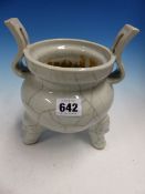 A CHINESE WHITE PORCELAIN TING, THE TWO HANDLED TRIPOD CENSER WITH THE GLAZE CRACKLED IN TWO TONES