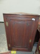 AN ANTIQUE SPINDLE BACK ROCKING CHAIR TOGETHER WITH A GEO.III. COUNTRY OAK CORNER CABINET. (2)