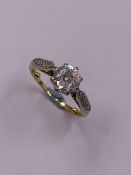 AN 18ct OLD BRILLIANT CUT DIAMOND SINGLE STONE MOUNTED IN 18ct YELLOW GOLD WITH A PLATINUM