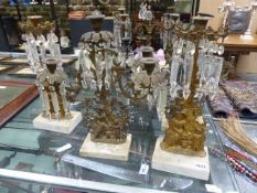A PAIR OF VICTORIAN THREE LIGHT GILT BRONZE CANDELABRA TOGETHER WITH A PAIR OF CANDLESTICKS, EACH OF