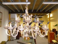 A HEAVY GILT BRASS EIGHTEEN LIGHT BAROQUE STYLE CHANDELIER, SCROLL ARMS WITH PUTTO MASK DECORATED