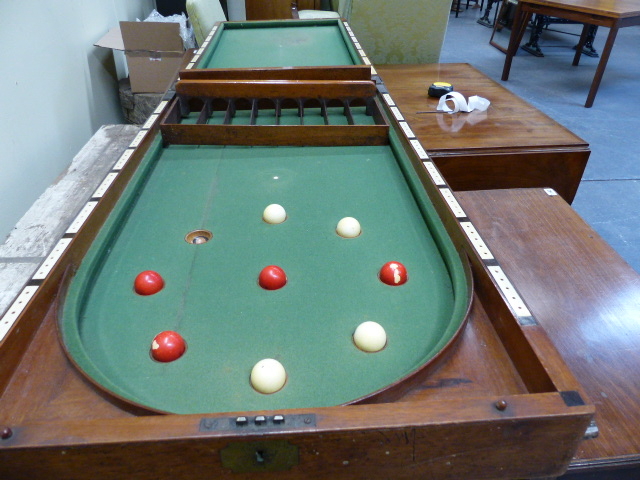 A VICTORIAN MAHOGANY FOLDING BAGATELLE TABLE COMPLETE WITH BALLS AND GUARDS.