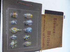 A ROMAN BOOK OF HAND PAINTED MAJOLICA DESIGNS, EACH GREY PAPER PAGE. 18.5 x 25cms. TOGETHER WITH A