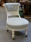 A VICTORIAN NURSING CHAIR WITH CARVED AND PAINTED SHOW FRAME.