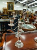 FIVE SILVER PLATE ON COPPER THREE BRANCH CANDELABRA AND TWO FURTHER CANDLESTICKS.