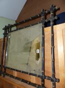 A LATE VICTORIAN AESTHETIC MOVEMENT WALL MIRROR WITH FAUX BAMBOO FRAME. 75 x 88cms.