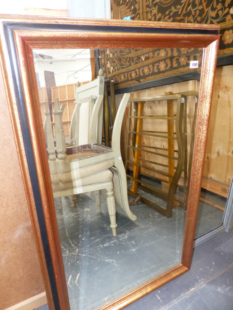 A PAIR OF VICTORIAN STYLE BEVEL EDGE WALL MIRRORS IN GILT AND EBONISED FRAMES. (2) 70 x 111cms.