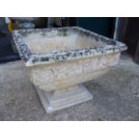 A PAIR OF COMPOSITE STONE PLANTERS WITH FLORAL BANDS BELOW THE SQUARE RIMS ON AND REMOVABLE FROM STE