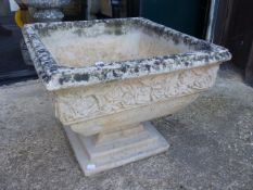 A PAIR OF COMPOSITE STONE PLANTERS WITH FLORAL BANDS BELOW THE SQUARE RIMS ON AND REMOVABLE FROM STE