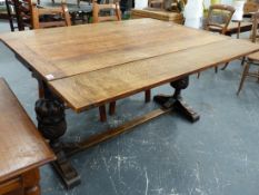 AN EARLY 20th.C.OAK EXTENDING DRAW LEAF TABLE ON CARVED BALLUSTER END SUPPORTS.