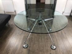 A NORMAN FOSTER DESIGNED NOMOS TABLE WITH CIRCULAR GLASS TOP OVER CHROME BASE. Dia.122 x H.67cms.