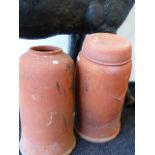 A GROUP OF THREE EARLY 20th.C.TERRACOTTA RHUBARB FORCERS, ONE WITH A LID. H.86cms. (4)