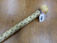 AN INDIAN IVORY WALKING CANE, THE BALL HANDLE ABOVE A TAPERING CYLINDRICAL STEM DECORATED WITH
