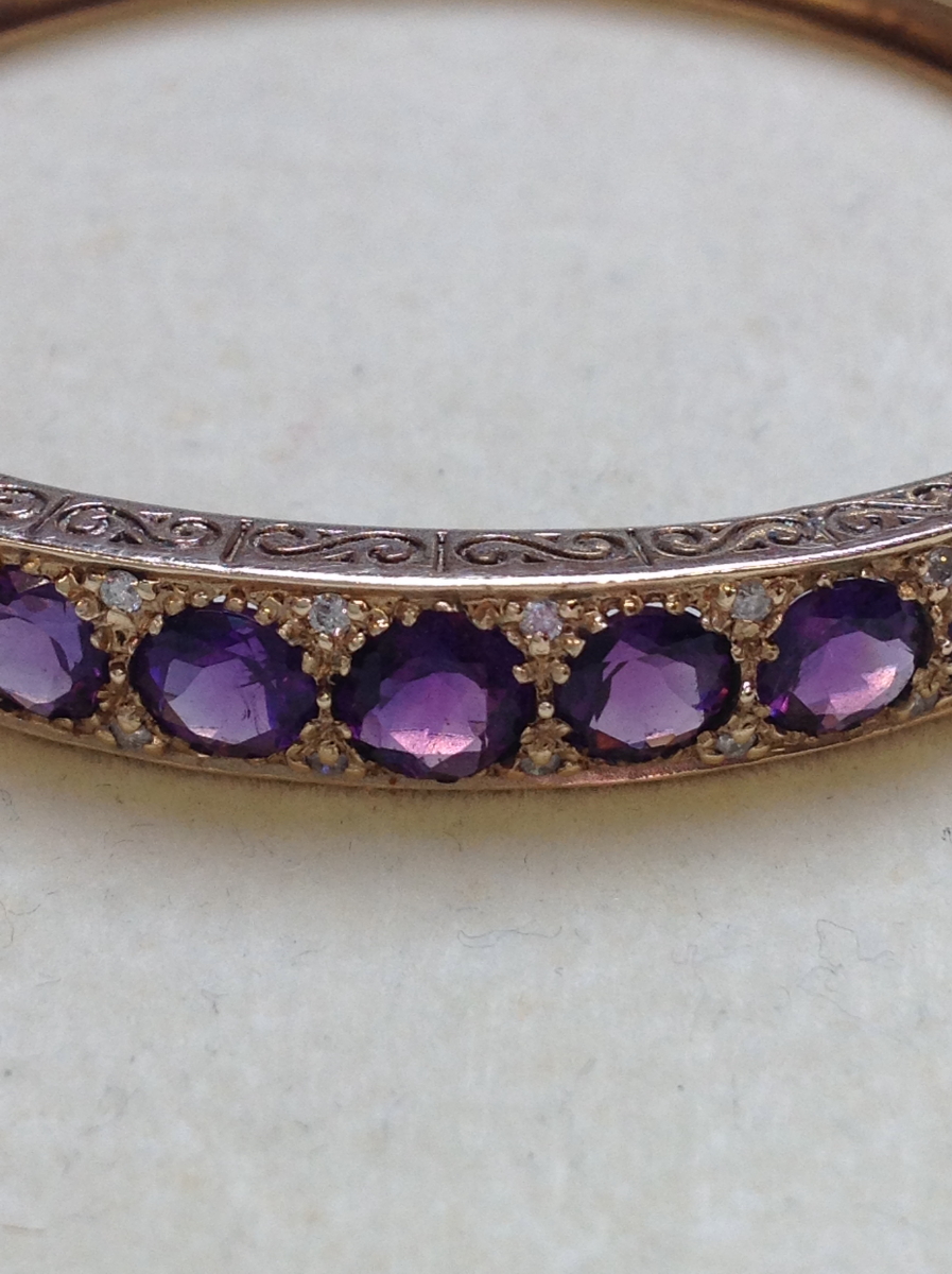 A 9ct GOLD AMETHYST AND DIAMOND CARVED HINGED BANGLE COMPLETE WITH FIGURE OF EIGHT SAFETY CLASP, - Image 13 of 14