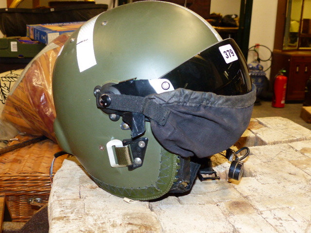 A MILITARY TYPE HELICOPTER PILOT'S HELMET WITH INTEGRAL HEADSET AND MICROPHONE.