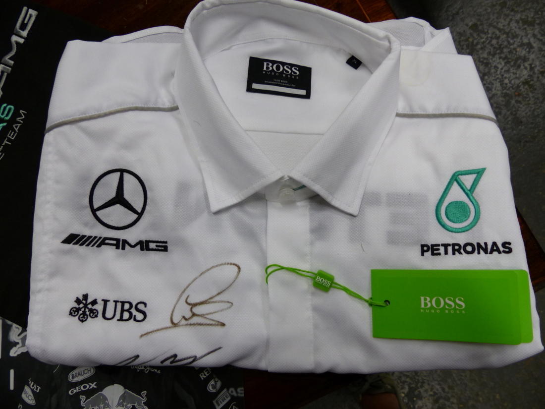 A COLLECTION OF PROGRAMMES AND CLOTHING SIGNED BY LEWIS HAMILTON, NELSON PIQUET, MARK WEBBER AND - Image 4 of 12
