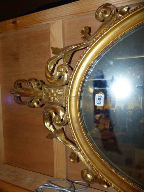 A 19th.C.OVAL MIRROR WITH GILT FOLIATE CREST AND BASE. 104 x 52cms. - Image 3 of 4